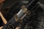 Chibi Xiaohan Sword hilt, wrapped in leather with a brass guard, showcasing its fine details.
