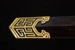 Qin Wang Sword scabbard mouth, showcasing its gold meander pattern and black scabbard connection.