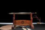 Han Xin Sword, an angled display of the sheathed sword on a wooden stand, showing its full form, scabbard, and stand.