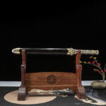 Beast King Sword in scabbard, presented on a wooden stand.