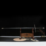 Lightweight European sword, an angled display of the unsheathed sword on a wooden stand, showing the complete shape of the blade, handle, and guard.