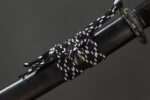 Close-up of Dark Plum katana handle with decorative cord
