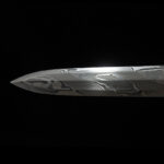 Qilin Sword tip, a close-up detail shot, showing the sharp edge and forging texture.