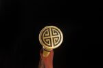 Qin Wang Sword hilt end, showing the golden round pommel and relief pattern.