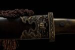 Mongolian knife handle and guard, close-up of the detailed metal engraving at the junction
