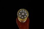 Beast King Sword hilt end, top-down view showing the intricate silver filigree and gold ornamentation.