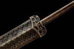 Han Xin Sword, a close-up detail of the handguard and handle, highlighting intricate geometric patterns and exquisite craftsmanship.