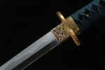 Red Night Sword blade and tsuba joint, showing blade pattern and golden guard details